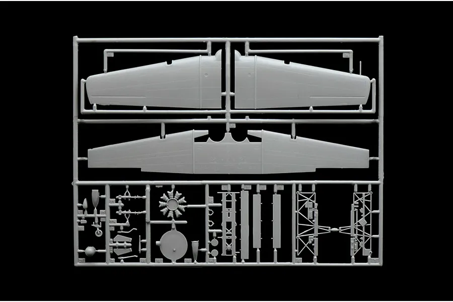 A grey plastic sprue from an Italeri 1/48 scale model aircraft kit, featuring wing sections, engine parts, and landing gear components.