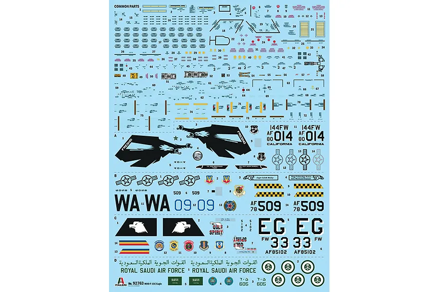 A decal sheet for an Italeri 1/48 F-15C Eagle model kit, featuring various markings, national insignia, and squadron emblems on a light blue backing.