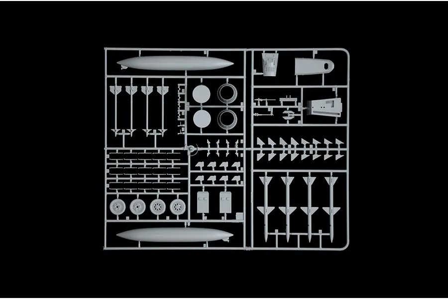 A grey plastic sprue containing various model aircraft parts including missiles, fuel tanks, and landing gear wheels for an F-15C Eagle model kit.