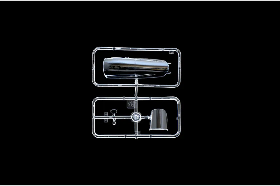 A clear plastic sprue containing two transparent aircraft canopy parts for a model kit, set against a black background.