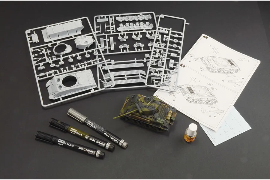 Italeri 1/56 Sherman M4A3E8 Fury model kit contents including grey plastic sprues, an assembled tank model, paint markers, glue, and instruction manual.