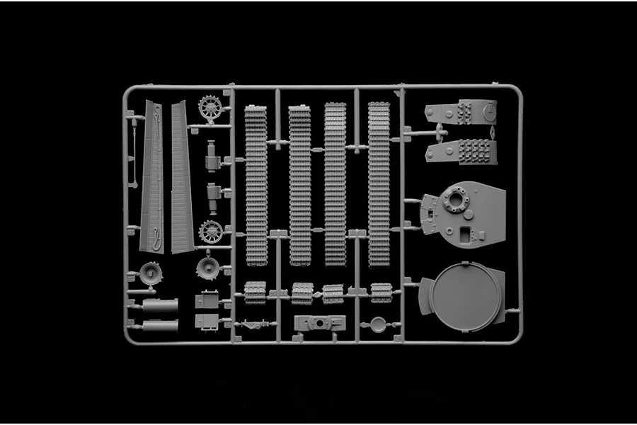 A grey plastic sprue containing various tank model parts, including track segments, turret components, and wheels, set against a black background.