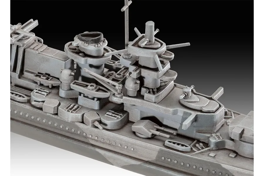 Close-up of the superstructure and deck details of a grey plastic model battleship, showing turrets, masts, and lifeboats.
