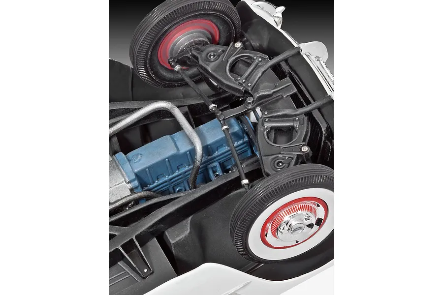 Close-up view of the detailed chassis and blue engine block of a 1/24 scale 1953 Chevrolet Corvette model car kit.