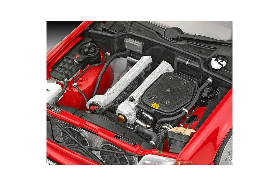 Close-up of the detailed engine bay of a 1/24 scale Revell Mercedes-Benz 300 SL-24 model car, showing the engine block, radiator, and red bodywork.