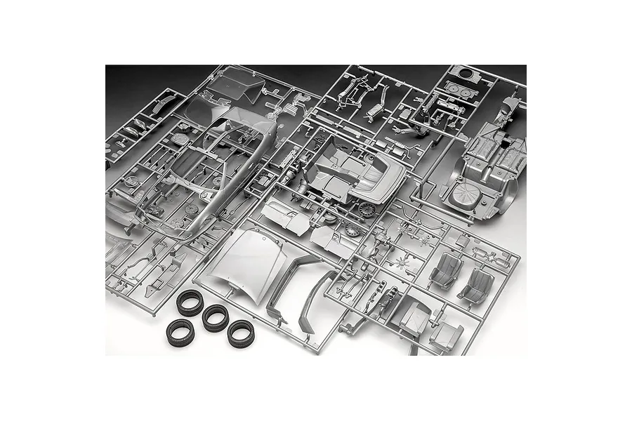 Unassembled plastic model car parts on sprues for a Revell Mercedes-Benz 300 SL-24, including body panels, interior, and four rubber tires.
