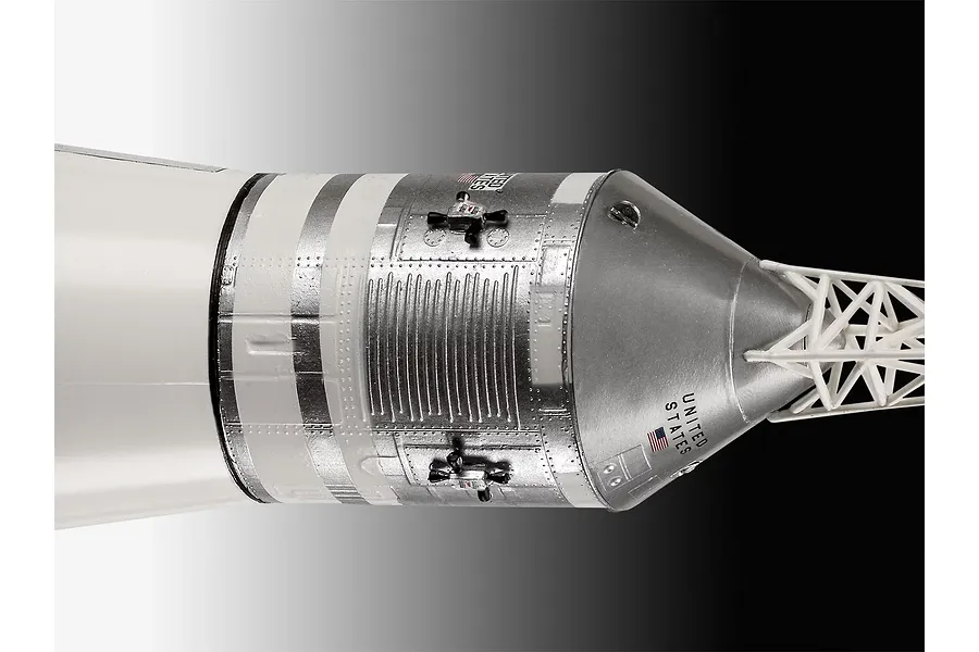 Close-up of the silver and white command module section of a Revell Saturn V rocket model kit.