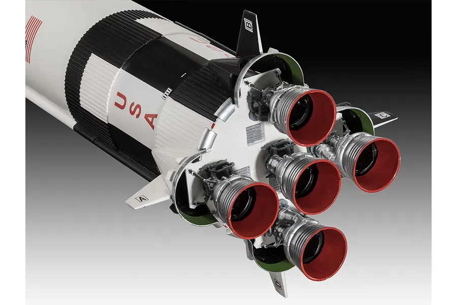 Close-up of the F-1 rocket engine cluster at the base of a Revell 1/96 scale Saturn V model rocket, showing detailed nozzles and markings.