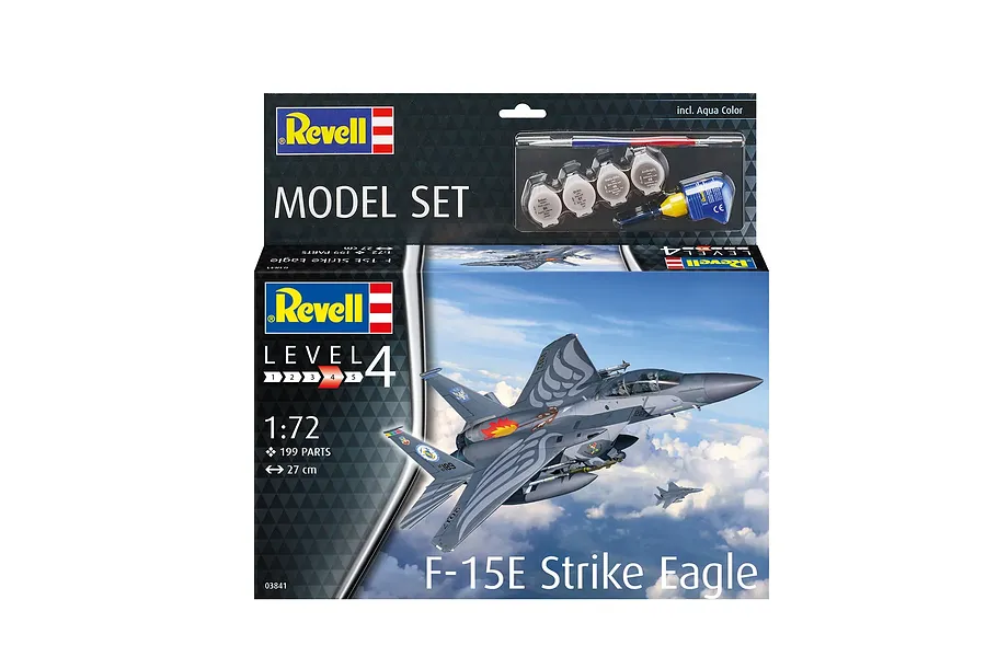 Revell 1/72 scale F-15E Strike Eagle plastic model kit box showing the finished aircraft in flight, including paint pots, glue, and a brush.