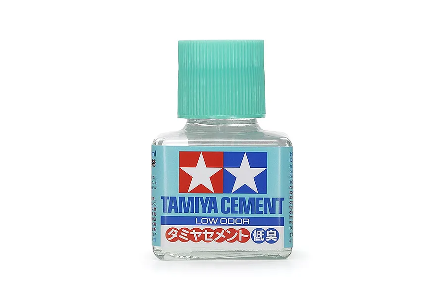 A 40ml bottle of Tamiya Low Odour Cement with a light green cap and a blue label featuring the Tamiya logo.