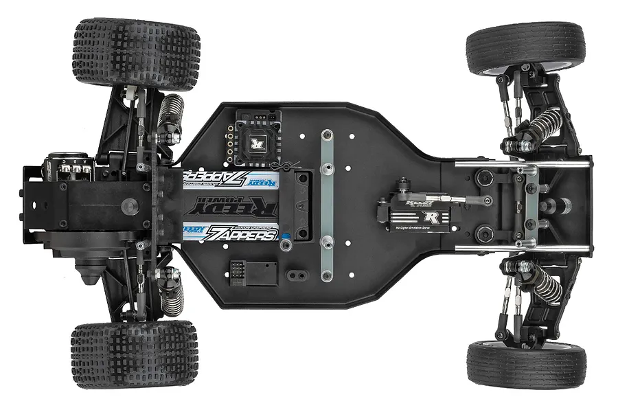 Top-down view of a Team Associated RC10 Sprint car chassis showing the internal components, battery, and tires on a white background.