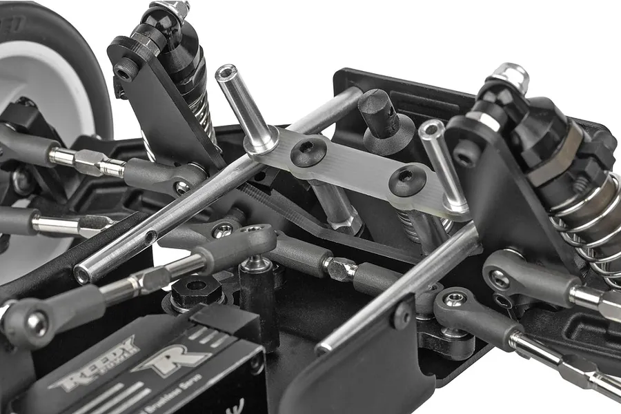 Close-up of the front suspension and steering assembly on a Team Associated RC10 Sprint car chassis.