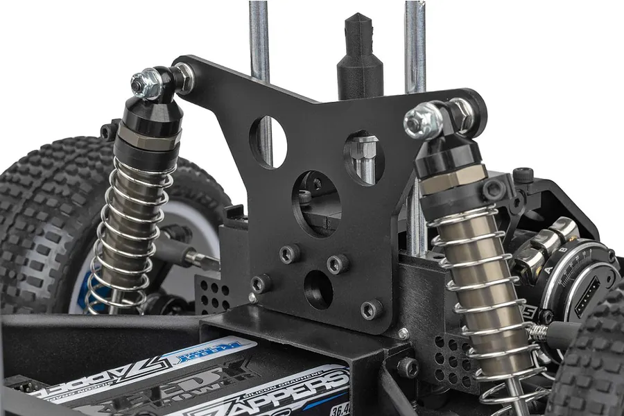 Close-up of the rear suspension tower and shock absorbers on a Team Associated RC10 Sprint car chassis.
