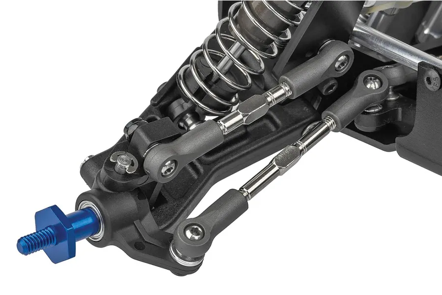 Close-up of the front suspension assembly of a Team Associated RC car, showing the shock absorber, steering linkage, and blue wheel hex.