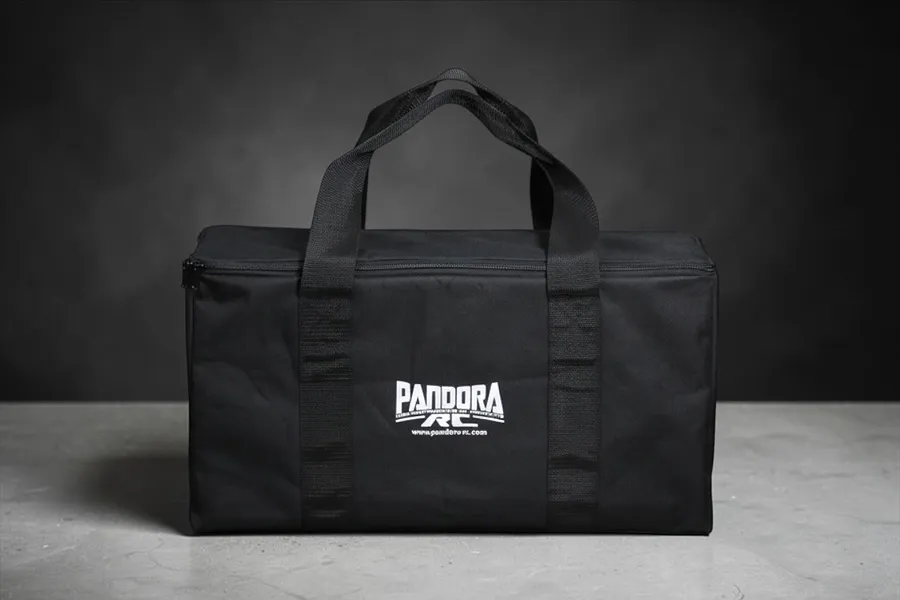 A black Pandora RC branded equipment bag sitting on a grey surface against a dark background.