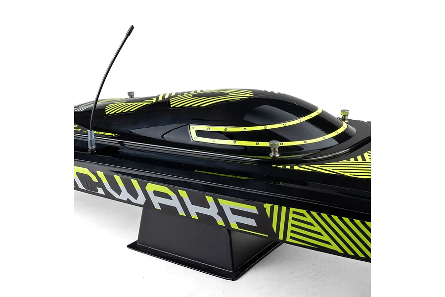 Close-up of the black and neon yellow hull and canopy of a Pro Boat Sonicwake V3 RC speed boat on a display stand.