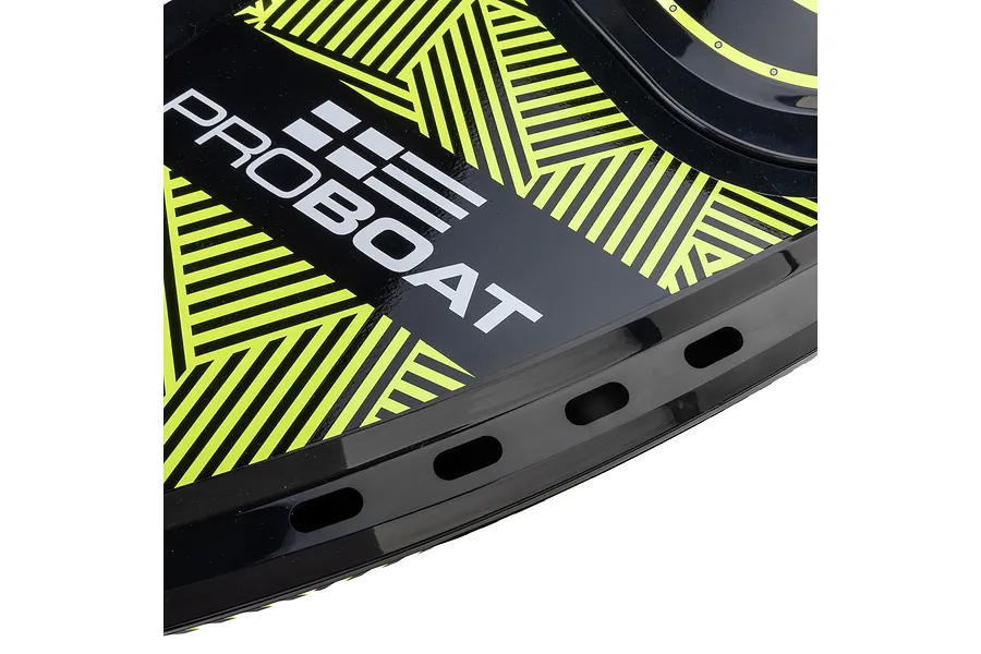 Close-up of the deck of a Pro Boat Sonicwake RC boat featuring a black and neon yellow geometric pattern and the Pro Boat logo.