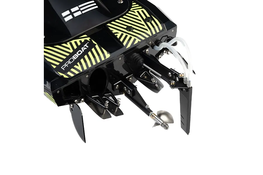 Close-up of the rear transom of a black Pro Boat Sonicwake RC speed boat showing the propeller, rudder, and trim tabs.