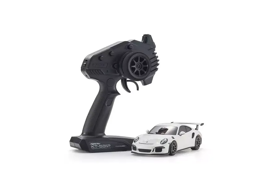 A white Kyosho Mini-Z Porsche 911 GT3 RS RC car next to a black Syncro KT-531P transmitter on a white background.
