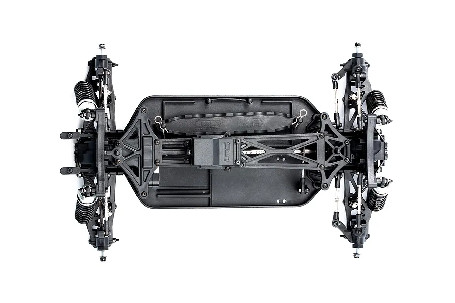 Top-down view of an LRP S10 Blast BX3 RC buggy chassis showing the black plastic frame, suspension arms, and shock absorbers on a white background.