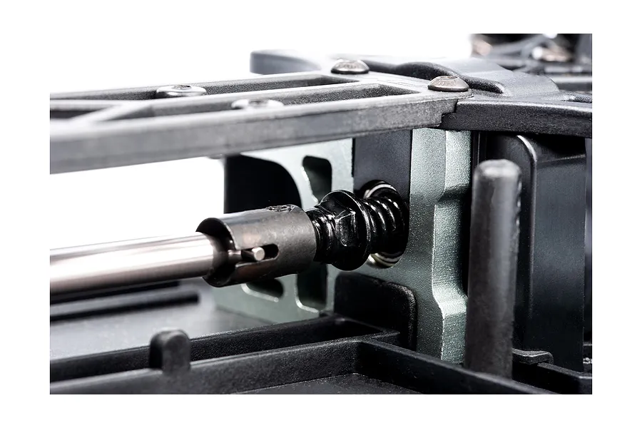 Close-up of the drivetrain and chassis components of an LRP S10 Blast RC buggy, showing the driveshaft, slipper clutch assembly, and metal motor mount.