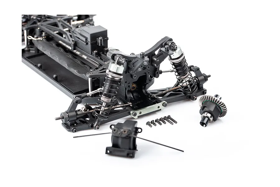 A partially assembled 1/10 scale RC buggy chassis showing the front suspension, differential, and various small screws on a white background.