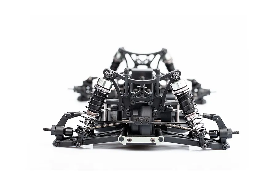 Front view of an LRP Antix S10 Blast BX3 RC buggy chassis showing suspension arms, shocks, and drivetrain components on a white background.