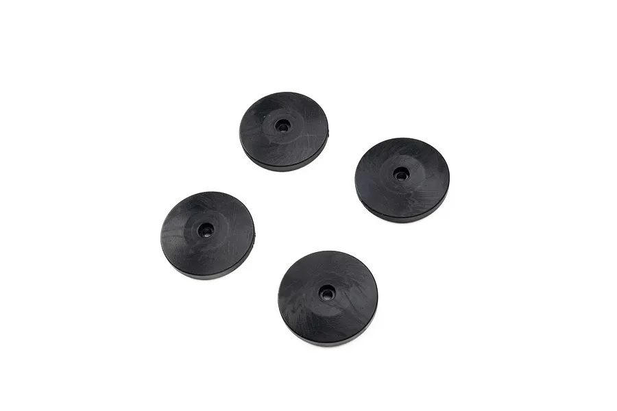Four black tapered shock pistons for RC cars arranged on a white background.