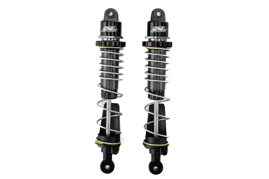 Two Pro-Line PowerStroke black aluminium rear RC shock absorbers standing vertically against a white background.