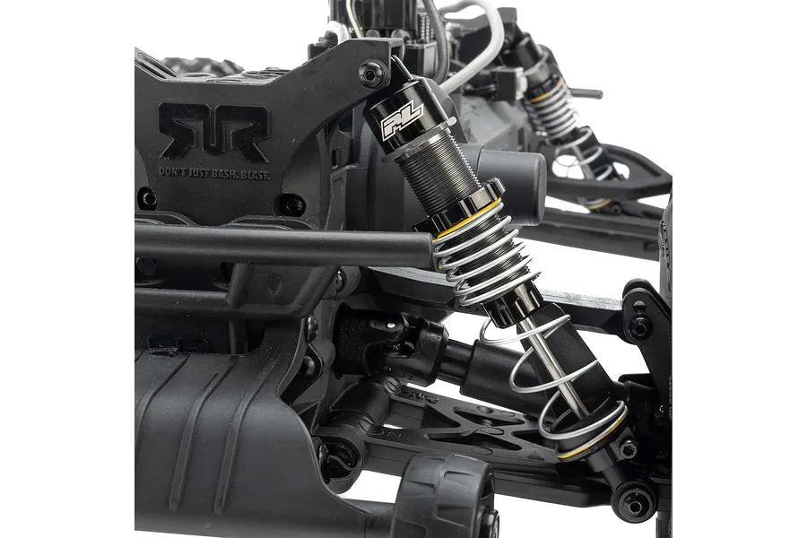 Close-up of a Pro-Line PowerStroke shock absorber installed on an RC vehicle chassis, featuring a black aluminium body and silver coil spring.