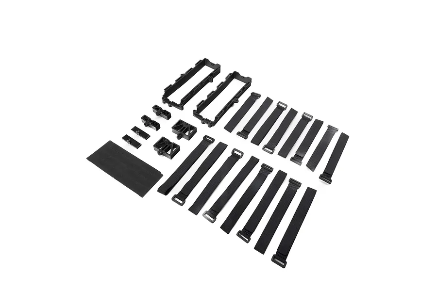 Losi battery tray and strap set including two plastic battery trays, several hook-and-loop straps, small plastic mounts, and a foam pad.
