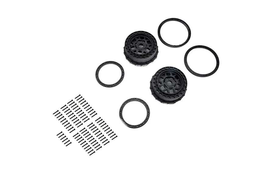 Pro-Line 3.1 inch black beadlock RC rims with matching rings and a set of mounting screws on a white background.