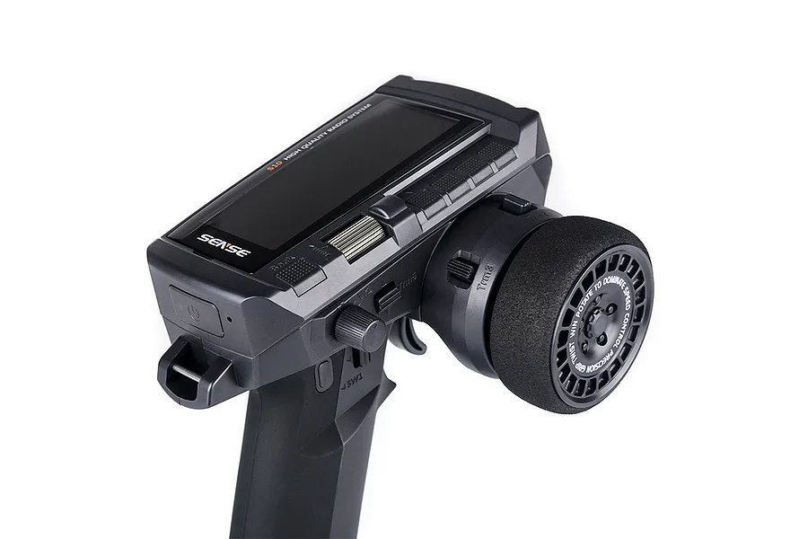 A close-up studio shot of the Sense Innovations S10 2.4GHz 10-channel RC transmitter, showing the steering wheel, display screen, and control buttons.
