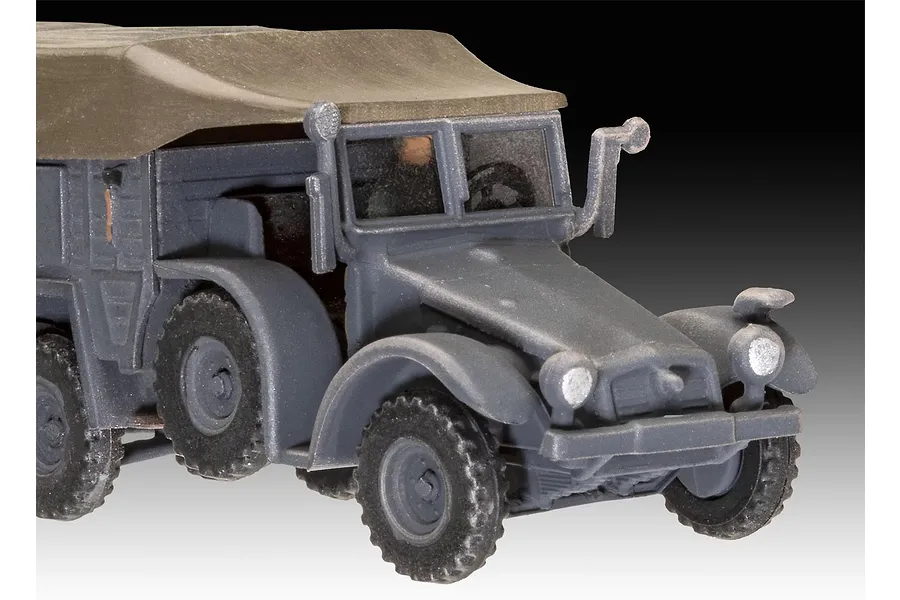 A close-up view of an assembled and unpainted grey plastic model of a Krupp Protze KFZ 69 military truck with a canvas-style top.
