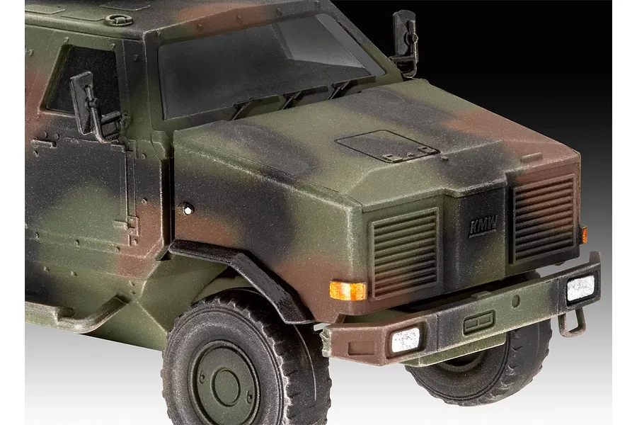 Close-up of a 1/72 scale plastic model of an ATF Dingo 1 military vehicle with camouflage paint.