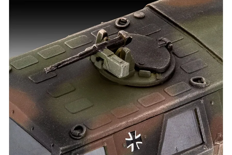 Close-up of the roof-mounted machine gun and hatch on a 1/72 scale Revell ATF Dingo 1 plastic model kit, featuring a camouflage paint scheme.