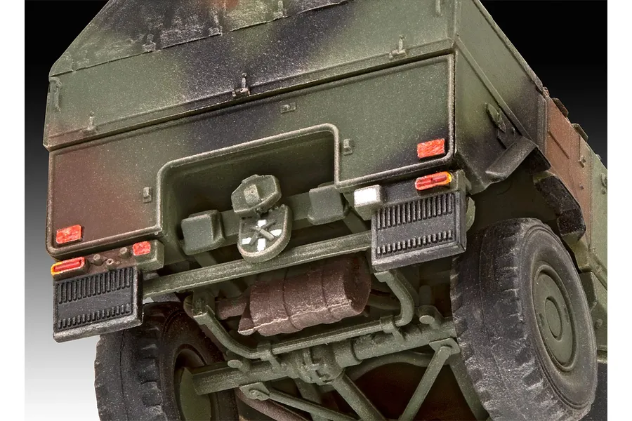 Close-up rear view of a 1/72 scale plastic model of an ATF Dingo 1 military vehicle, showing the chassis, exhaust, and camouflage paint scheme.