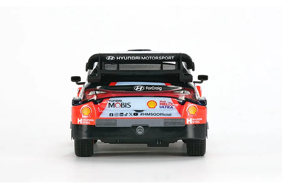 Rear view of the Carisma Hyundai i20N Rally1 RC car, showing the spoiler, sponsor decals, and exhaust detail against a white background.