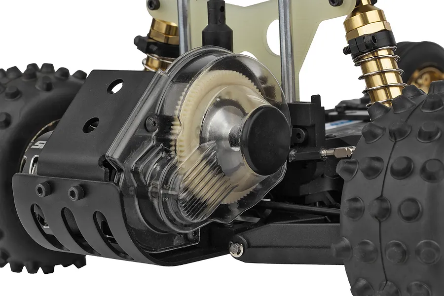 Close-up of the rear gear cover and motor area of a Team Associated RC10 Ultra Fox RC buggy, showing the clear plastic gear cover and gold shocks.