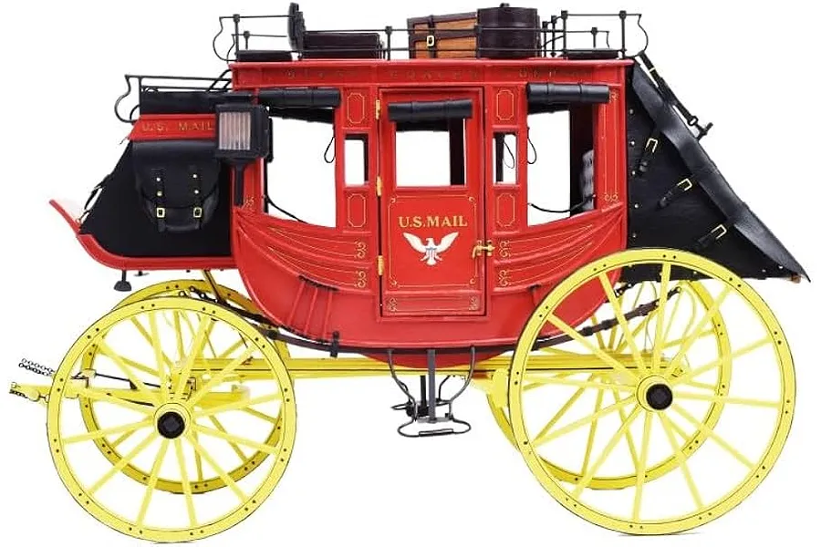 A detailed 1/12 scale wooden model of an 1848 Wild West stagecoach with a red body, yellow wheels, and black leather-look accents.