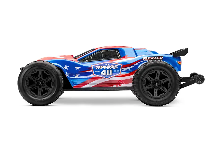 Side profile of a Traxxas Rustler 40th Anniversary edition RC stadium truck with a blue, white, and red patriotic paint scheme.