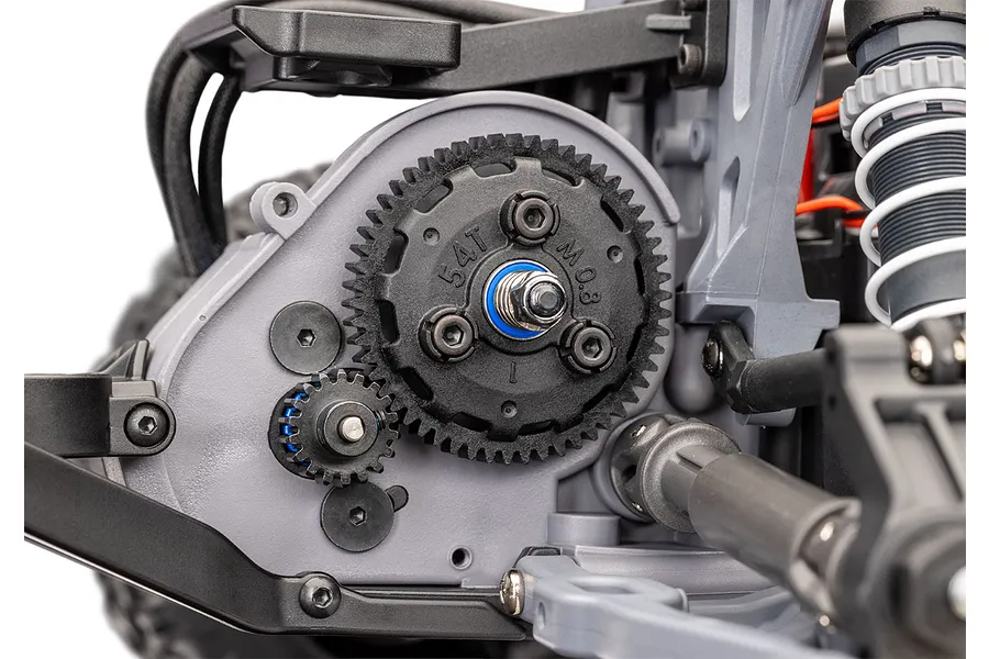 Close-up of the spur gear and pinion gear assembly on a Traxxas RC vehicle chassis, showing the 54T gear and surrounding suspension components.