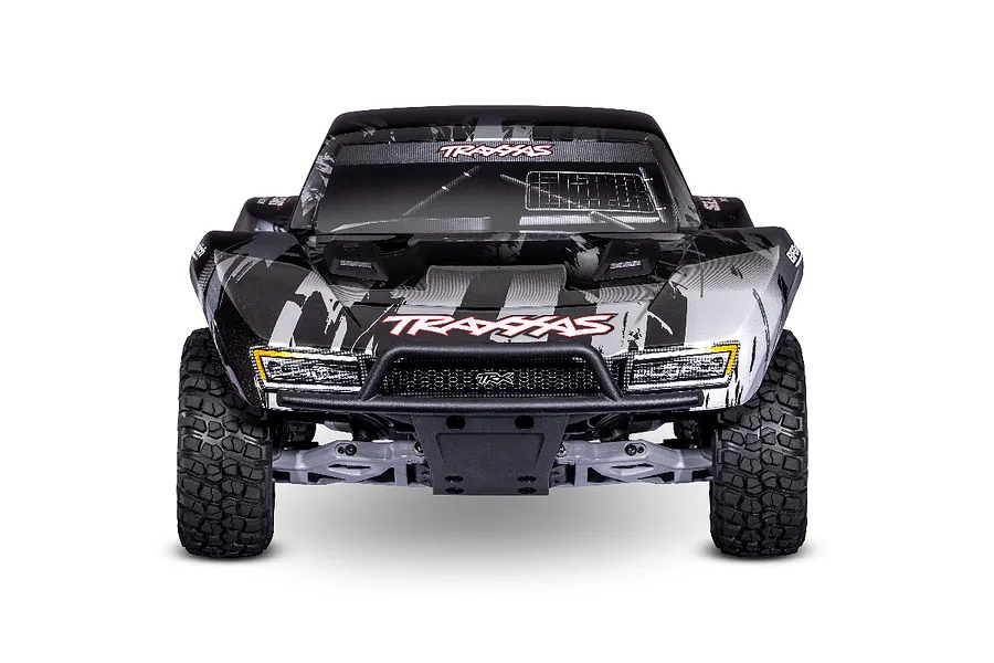 Front view of a Traxxas Slash 2WD RC short course truck with a black and silver graphic body, featuring a front bumper and off-road tires.