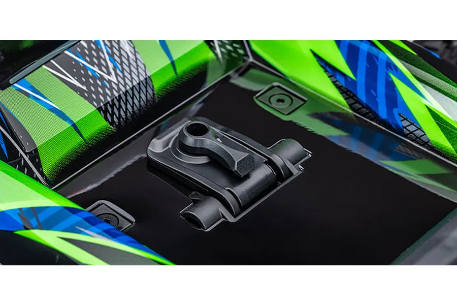 Close-up of the clipless body mounting latch on a green and blue Traxxas RC truck body.