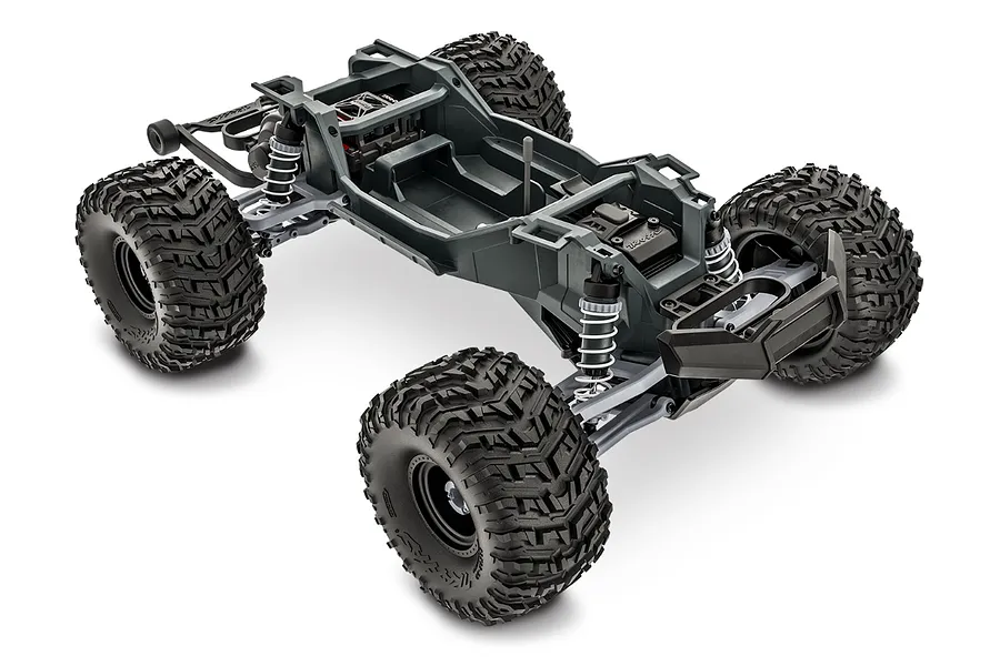 A high-angle studio shot of a Traxxas Stampede 2WD RC monster truck chassis without the body shell, showing the frame, suspension, and large treaded tires.