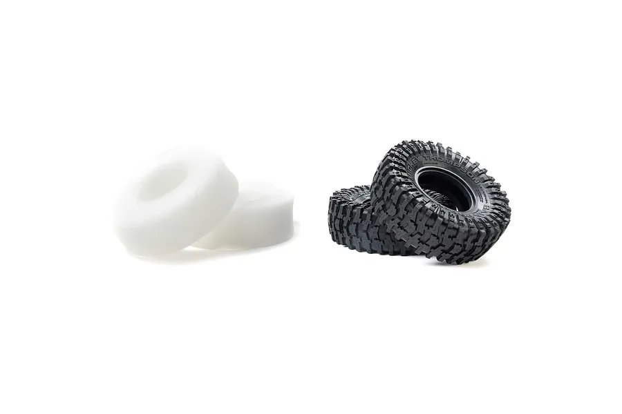 Two Pro-Line 1.9 inch Mickey Thompson Baja Pro XS crawler tyres and two white foam inserts isolated on a white background.