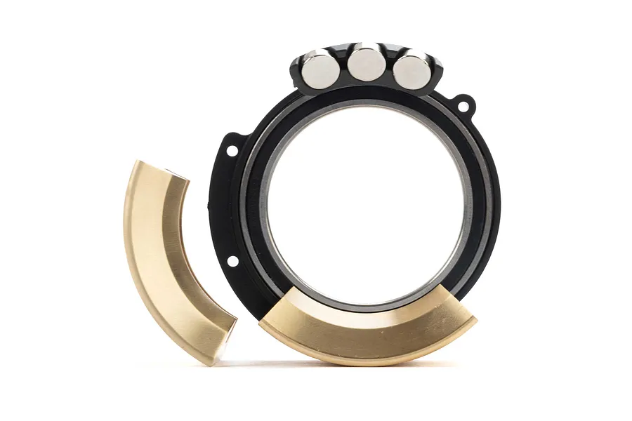 Pro-Line 1.9 inch Rock-Tek tyre weight set showing a black circular wheel weight mount with brass segments and small silver weights.
