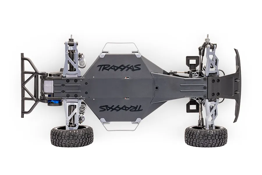 Top-down view of a Traxxas Slash 2WD RC truck chassis on a white background, showing the main tub, suspension arms, and rear bumper.