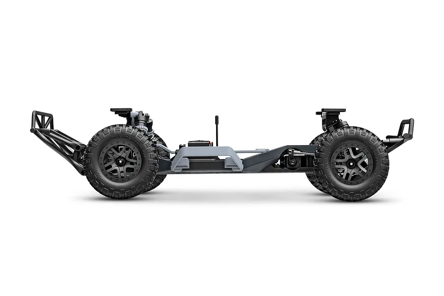 Side profile view of a Traxxas Slash 2WD RC truck chassis without the body shell, showing the frame, wheels, and suspension components.