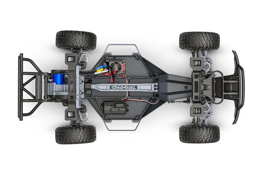 Top-down view of a Traxxas Slash 2WD RC truck chassis showing the internal components, motor, battery tray, and suspension system.